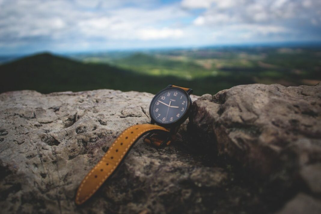 watch laying upright on mountain overlooking the valley