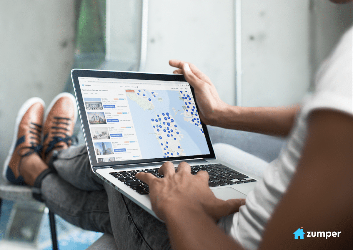 Man searching on Zumper with laptop