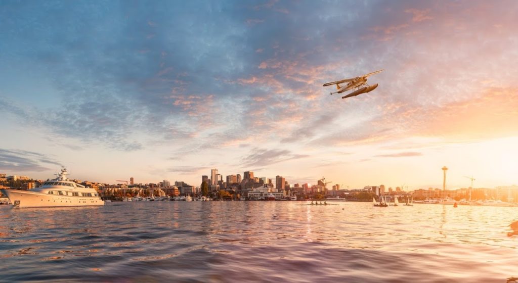 picture of airplane flying over water in seattle