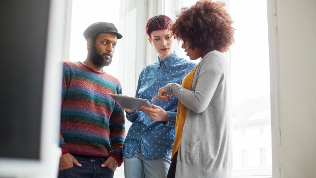 people reviewing material on a mobile tablet
